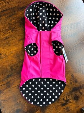 Adorable dog raincoat in hot pink with black & white polka dot lining.